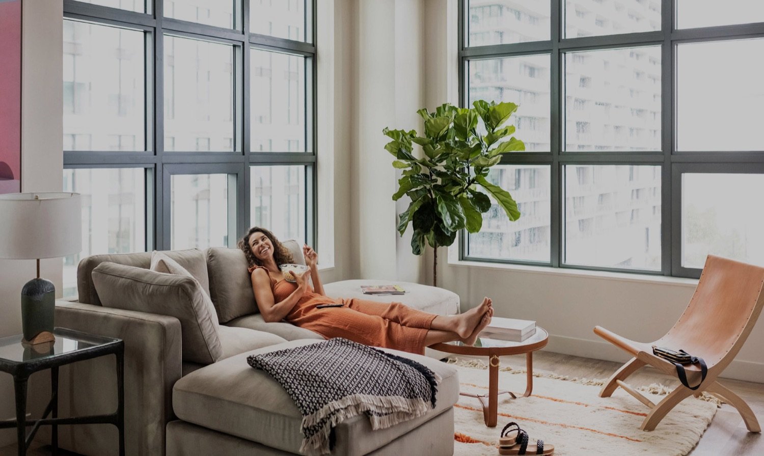 A guest relaxing in a ROOST apartment hotel living room