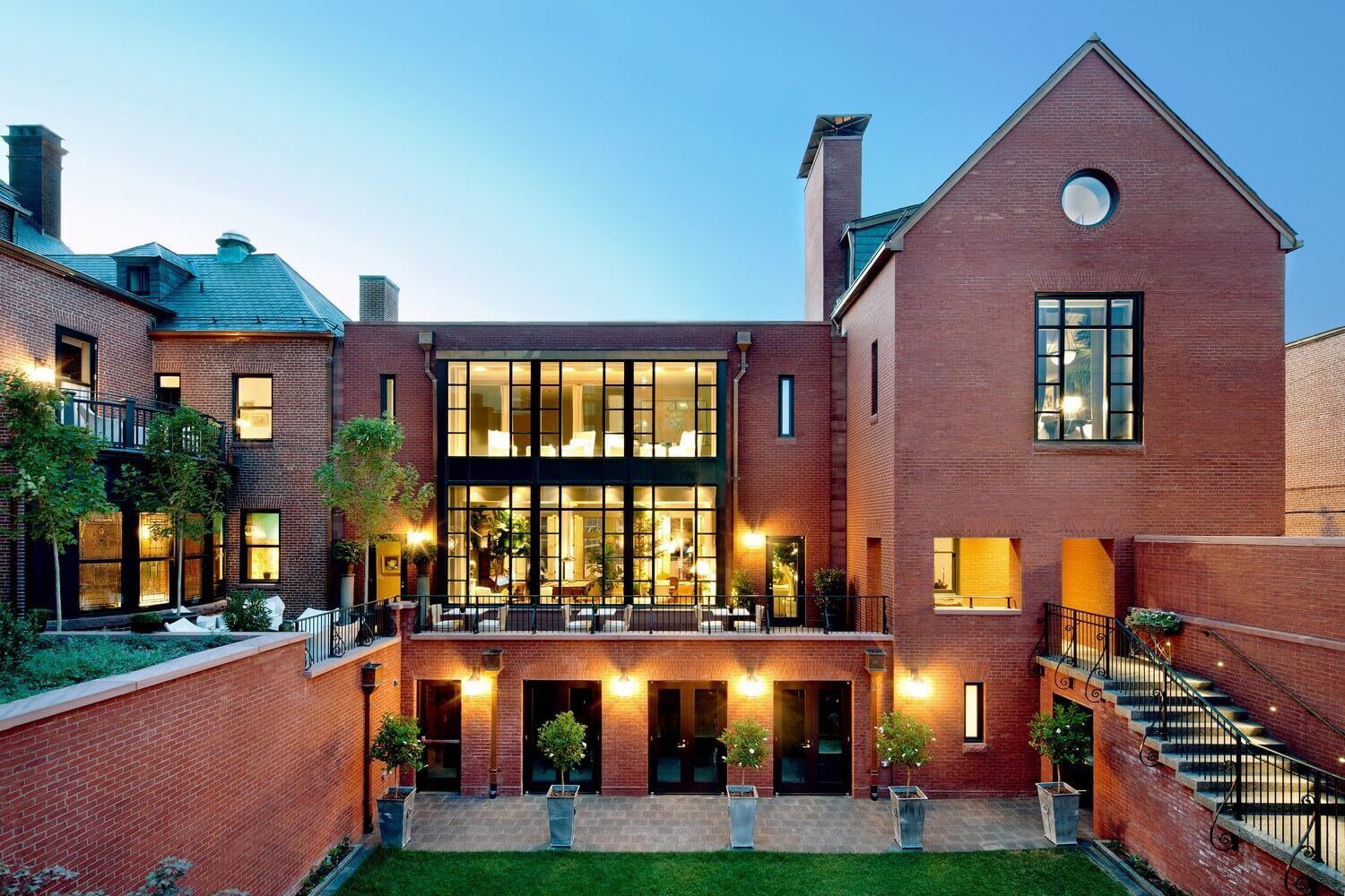 A luxury hotel exterior lit at dusk