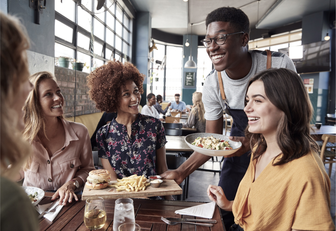 waiter-serving-group-of-female-friends-meeting-2