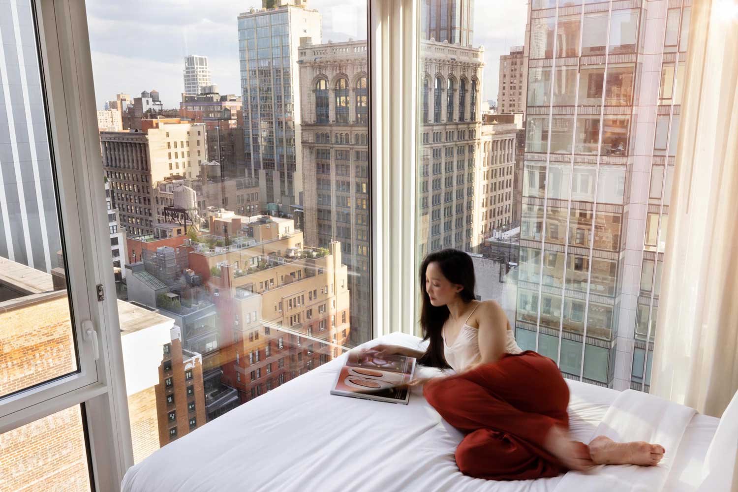 Guest enjoying city views from Arlo NoMad hotel room in Midtown Manhattan