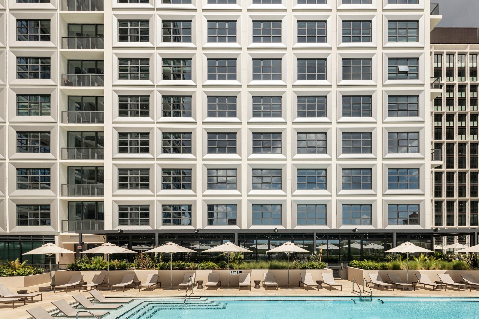 Exterior of Roost Tampa extended-stay hotel with pool and sun terrace in Water Street district