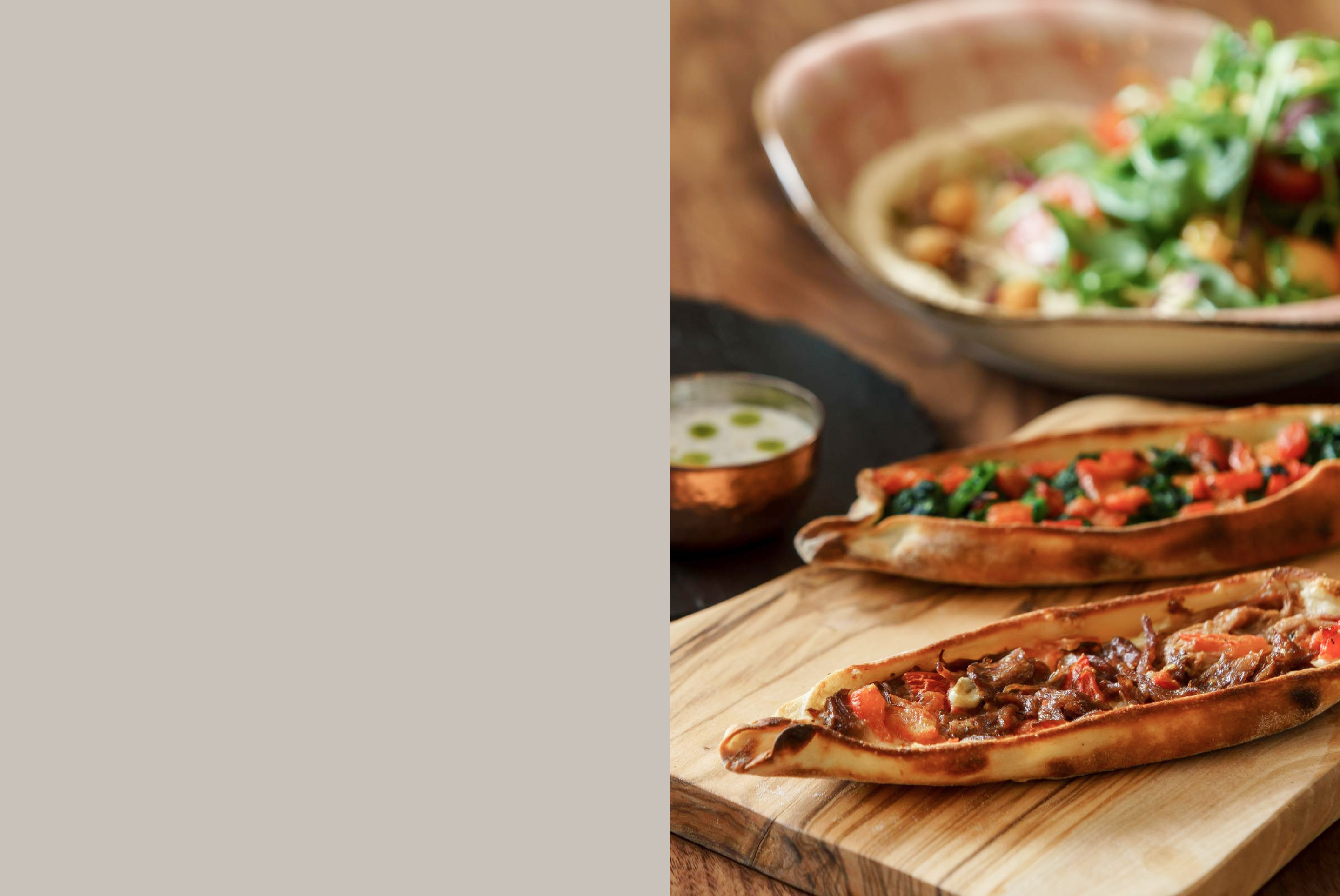 Pizza on brown wooden chopping board